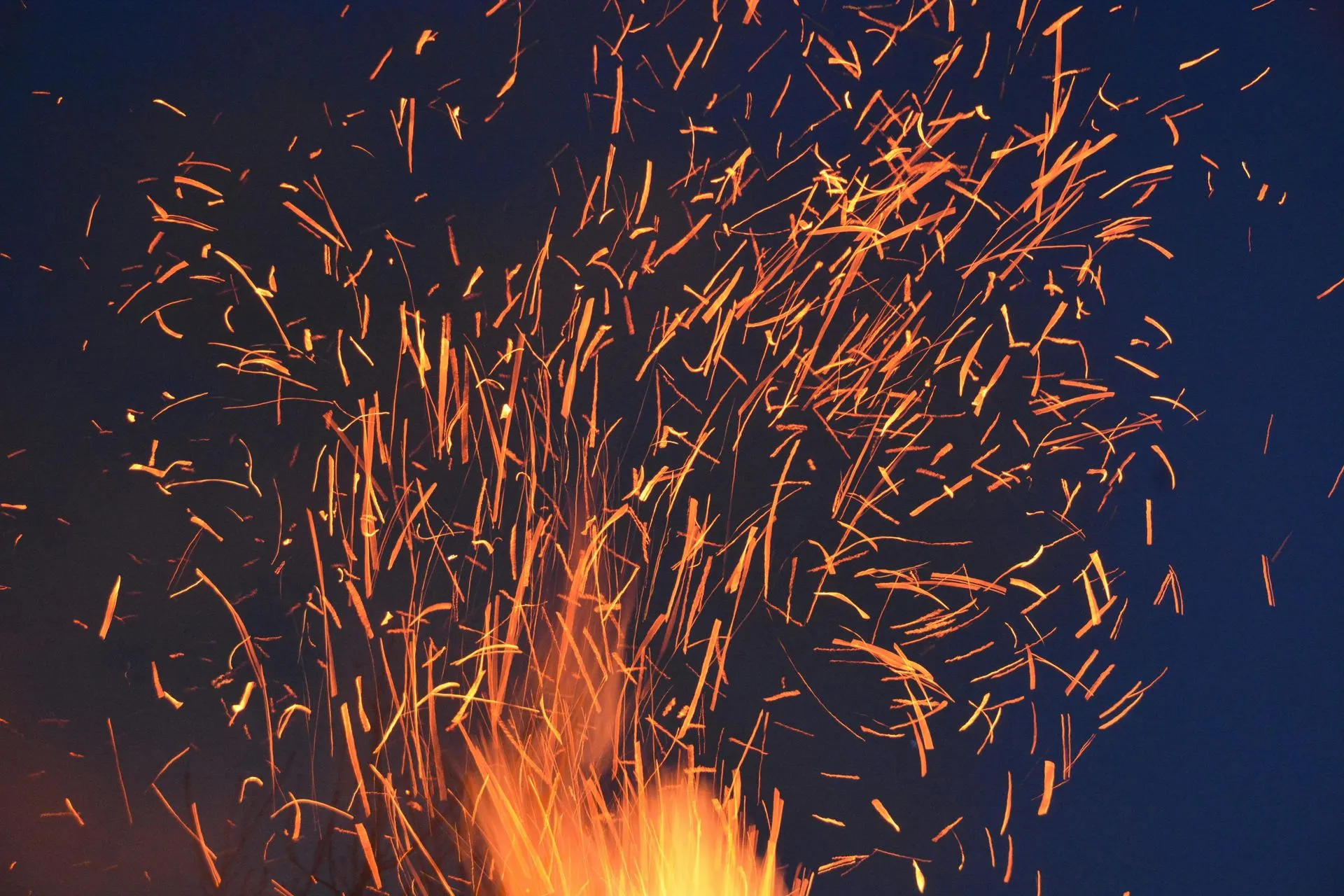 Sparks rising from a campfire at night