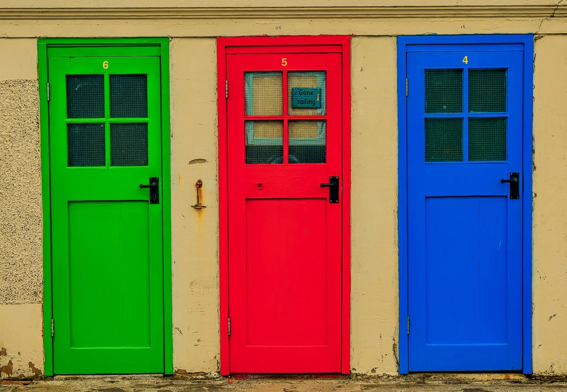 Three brightly painted doors side by side